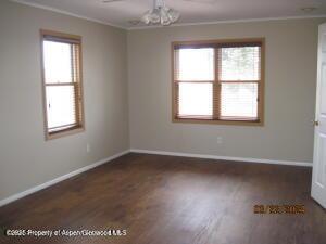 1645 E 7th St, Craig, CO 81625 - unfurnished room with ornamental molding, wood finished floors, and baseboards