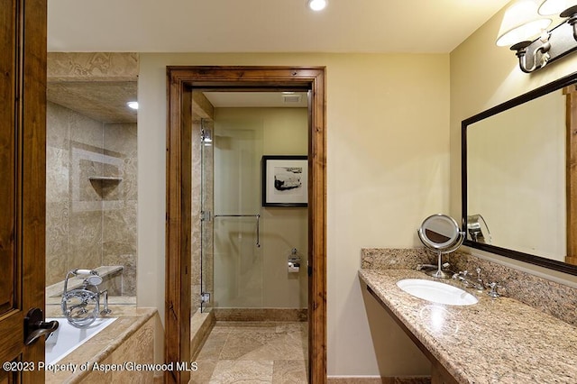 415 E Dean St Week 7 St, Aspen, CO 81611 - bathroom with a stall shower, tiled bath, and vanity