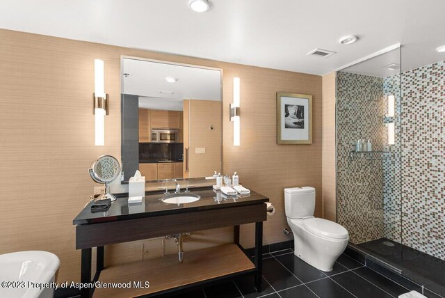 bathroom with tile patterned floors, toilet, a shower with shower door, and sink