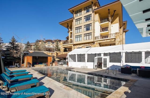 rear view of house featuring a community pool