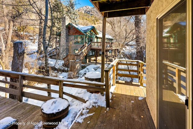 snow covered deck featuring a mountain view