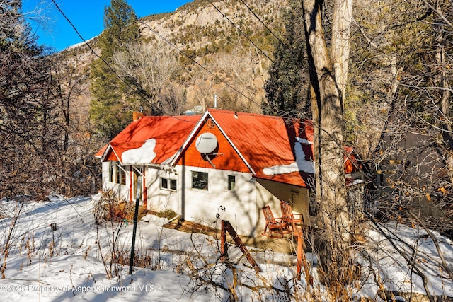 snow covered property with a mountain view