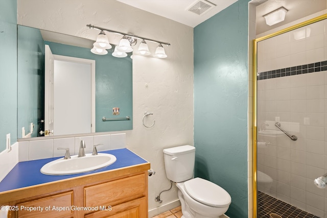 bathroom with tasteful backsplash, vanity, tile patterned flooring, toilet, and a shower with shower door