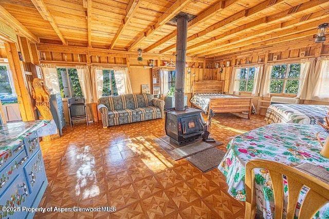 1136 Dipper Dr, Craig, CO 81625 - bedroom featuring a wood stove and wood ceiling with exposed beams