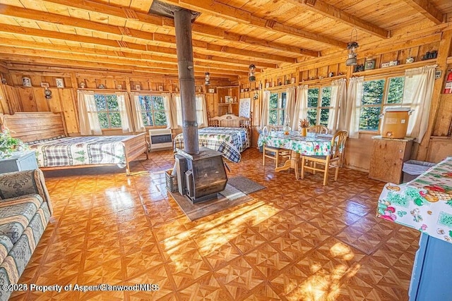 1136 Dipper Dr, Craig, CO 81625 - bedroom featuring multiple windows, wood ceiling with exposed beams, and a wood stove