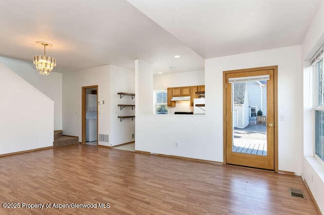 1608 Crawford Way, Glenwood Springs, CO 81601 - unfurnished living room featuring light wood-style flooring, a chandelier, baseboards, and recessed lighting