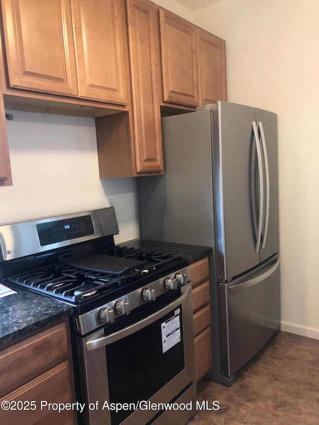 1608 Crawford Way, Glenwood Springs, CO 81601 - kitchen with stainless steel range with gas cooktop, baseboards, dark stone countertops, and dark wood-style floors