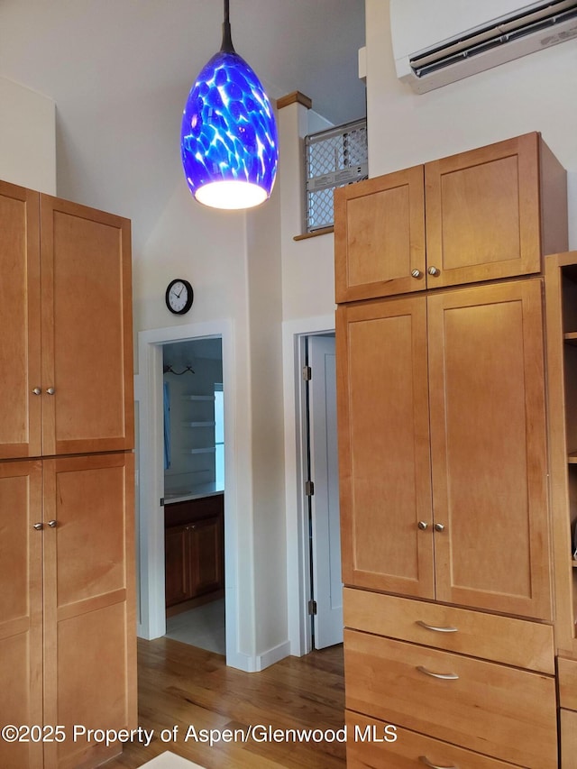 1608 Crawford Way, Glenwood Springs, CO 81601 - unfurnished bedroom with a wall mounted AC, dark wood-style floors, a high ceiling, and baseboards