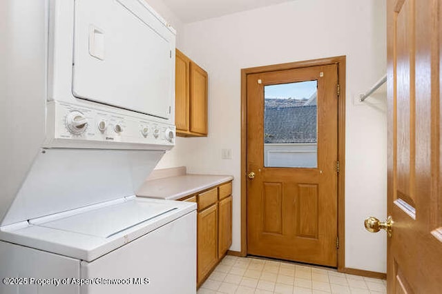 1608 Crawford Way, Glenwood Springs, CO 81601 - washroom featuring stacked washer / dryer, cabinet space, and baseboards