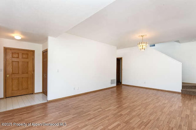 1608 Crawford Way, Glenwood Springs, CO 81601 - unfurnished living room featuring a chandelier, light wood-style flooring, and baseboards