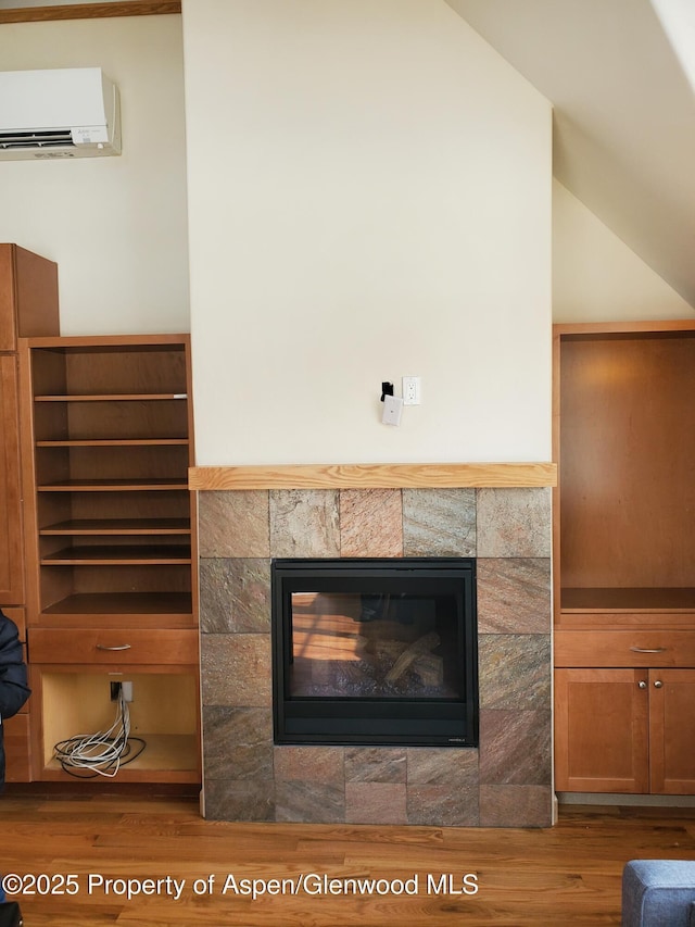 1608 Crawford Way, Glenwood Springs, CO 81601 - detailed view of a wall unit AC, wood finished floors, and a tiled fireplace