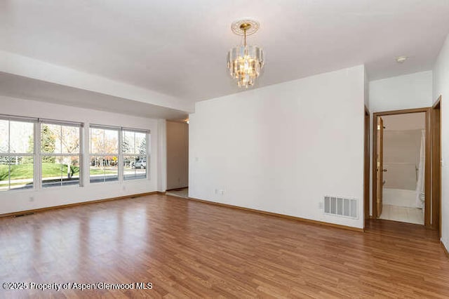 1608 Crawford Way, Glenwood Springs, CO 81601 - unfurnished room featuring a chandelier, wood finished floors, and baseboards