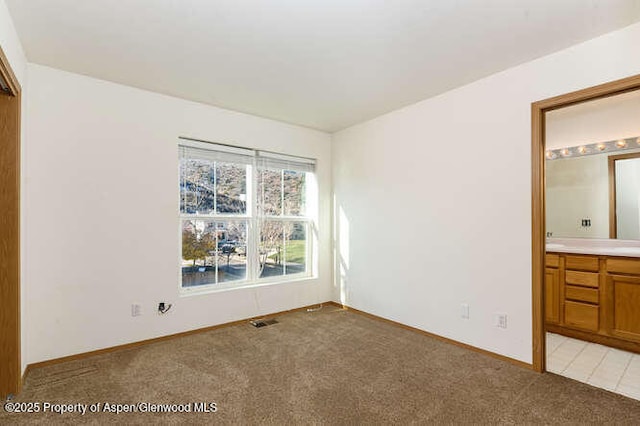 1608 Crawford Way, Glenwood Springs, CO 81601 - unfurnished bedroom with light carpet, baseboards, and ensuite bathroom