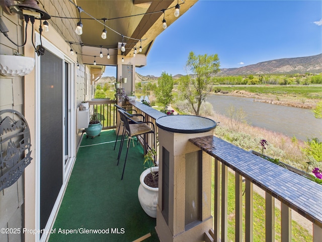 balcony with a water and mountain view