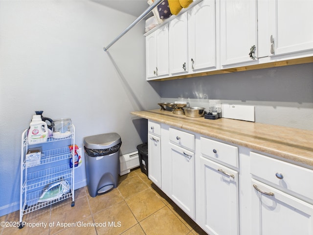 laundry room featuring light tile patterned floors and a baseboard heating unit