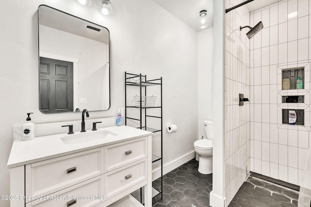 1600 County Road 30, Craig, CO 81625 - bathroom featuring toilet, vanity, a tile shower, and baseboards