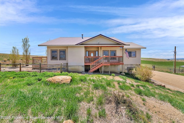 1600 County Road 30, Craig, CO 81625 - view of front of home with fence, metal roof, and a porch