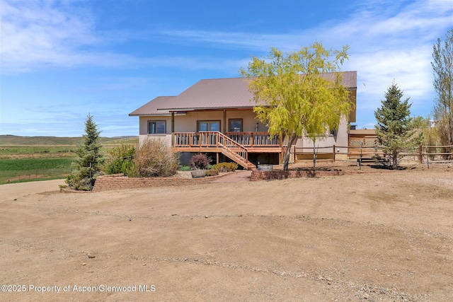 1600 County Road 30, Craig, CO 81625 - rear view of house with fence, covered porch, and metal roof