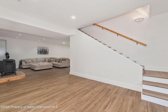 1600 County Road 30, Craig, CO 81625 - living room featuring stairs, light wood-style floors, a wood stove, recessed lighting, and baseboards