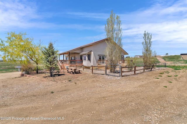 1600 County Road 30, Craig, CO 81625 - view of front of home featuring fence, stucco siding, and a rural view