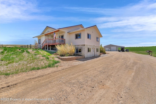 1600 County Road 30, Craig, CO 81625 - rear view of house featuring a garage, dirt driveway, and stucco siding