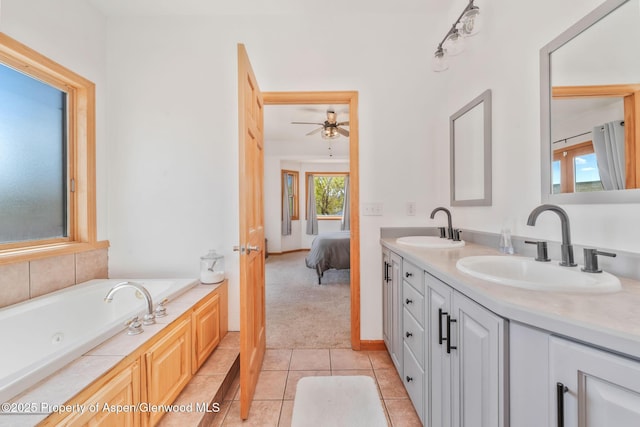 1600 County Road 30, Craig, CO 81625 - bathroom with tile patterned floors, a ceiling fan, a tub with jets, double vanity, and ensuite bath
