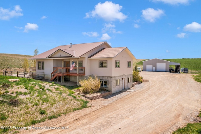 1600 County Road 30, Craig, CO 81625 - view of home's exterior with a detached garage, dirt driveway, fence, metal roof, and an outdoor structure