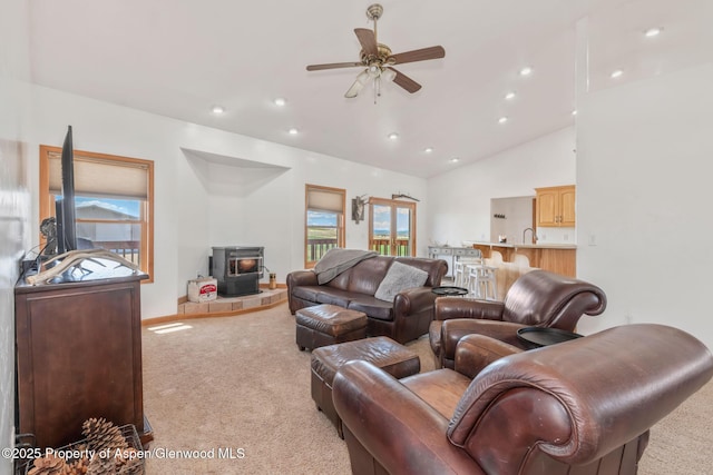1600 County Road 30, Craig, CO 81625 - carpeted living area with a wood stove, a ceiling fan, vaulted ceiling, recessed lighting, and a sink