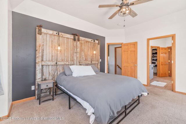 1600 County Road 30, Craig, CO 81625 - bedroom with light carpet, baseboards, a walk in closet, and ceiling fan
