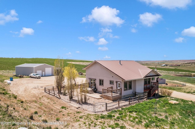 1600 County Road 30, Craig, CO 81625 - rear view of house with a detached garage, fence, an outbuilding, and a view of countryside