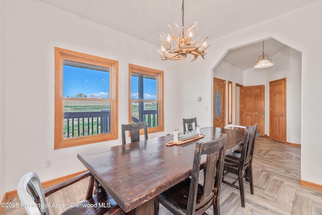 1600 County Road 30, Craig, CO 81625 - dining area with a chandelier, baseboards, and arched walkways