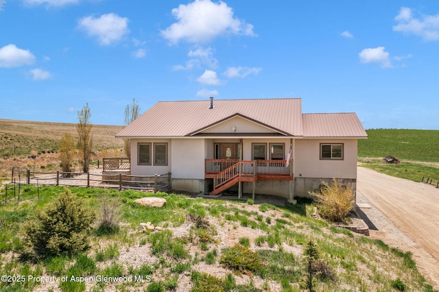 1600 County Road 30, Craig, CO 81625 - single story home with metal roof, fence, and a porch