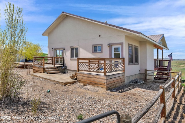 1600 County Road 30, Craig, CO 81625 - back of house with a wooden deck, metal roof, and stucco siding