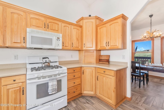 1600 County Road 30, Craig, CO 81625 - kitchen with white appliances, a chandelier, light countertops, and light brown cabinets