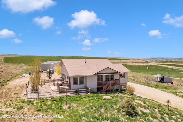 1600 County Road 30, Craig, CO 81625 - back of property featuring a rural view, metal roof, an outdoor structure, fence, and stairway
