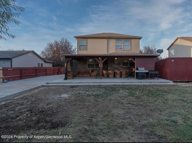 back of property featuring a shed and a patio area