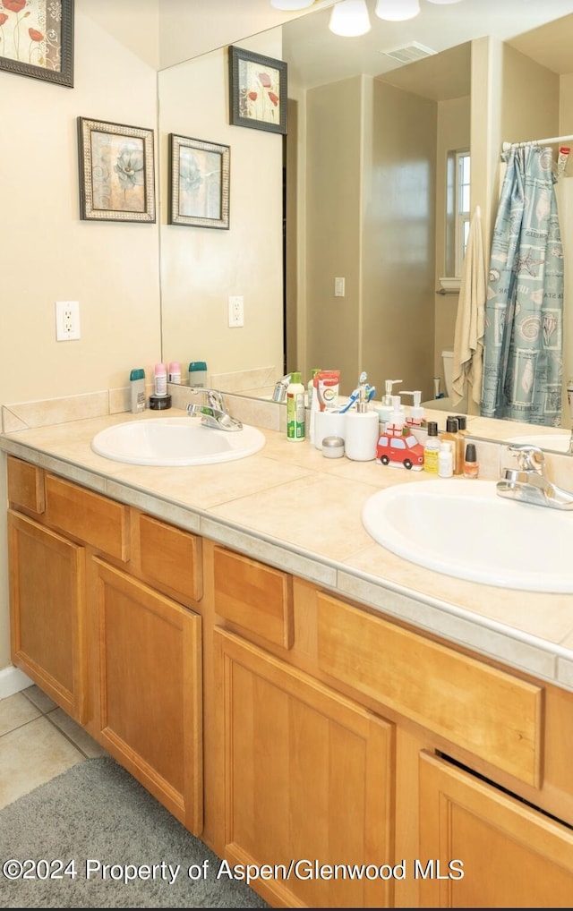 bathroom with tile patterned flooring and vanity