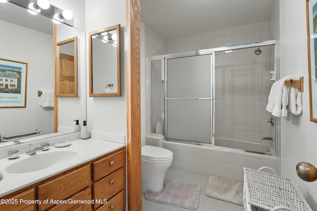 full bathroom featuring shower / bath combination with glass door, tile patterned floors, vanity, and toilet