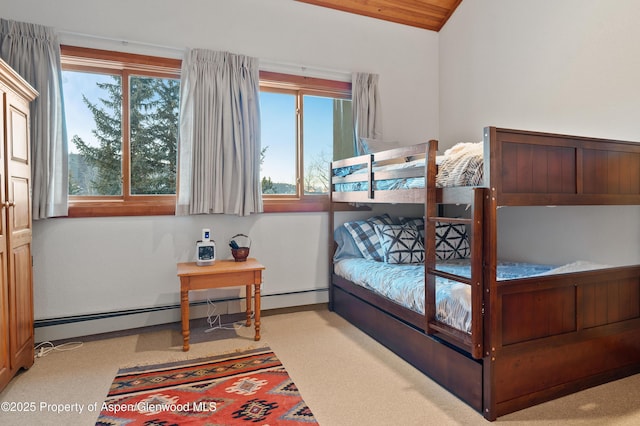 bedroom featuring baseboard heating, light colored carpet, and vaulted ceiling