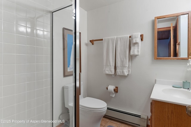 bathroom featuring tile patterned flooring, vanity, a baseboard heating unit, toilet, and a shower with door