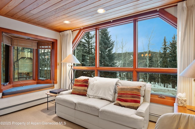 sunroom / solarium featuring wood ceiling and a baseboard heating unit