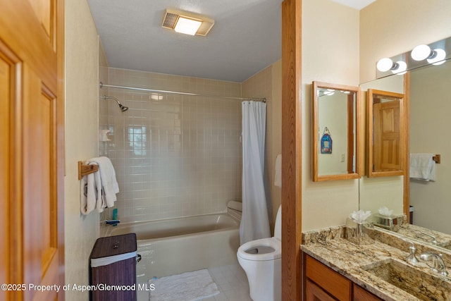 full bathroom with shower / tub combo with curtain, vanity, a textured ceiling, tile patterned floors, and toilet