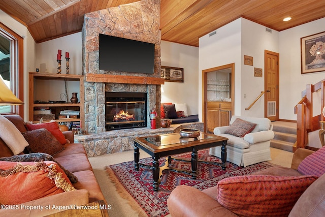 carpeted living room featuring a stone fireplace and wood ceiling