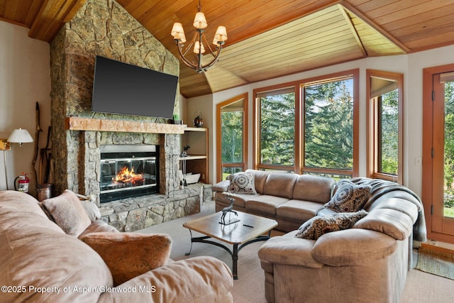 living room with wood ceiling, lofted ceiling, a fireplace, and a notable chandelier