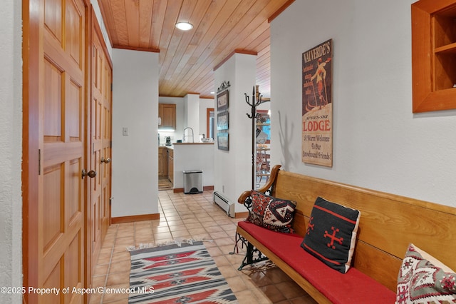 hallway featuring crown molding, light tile patterned flooring, wood ceiling, and baseboard heating