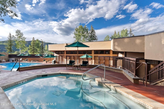 view of swimming pool with a mountain view