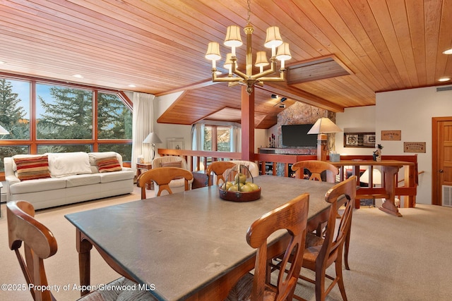 dining room with wood ceiling, an inviting chandelier, and carpet