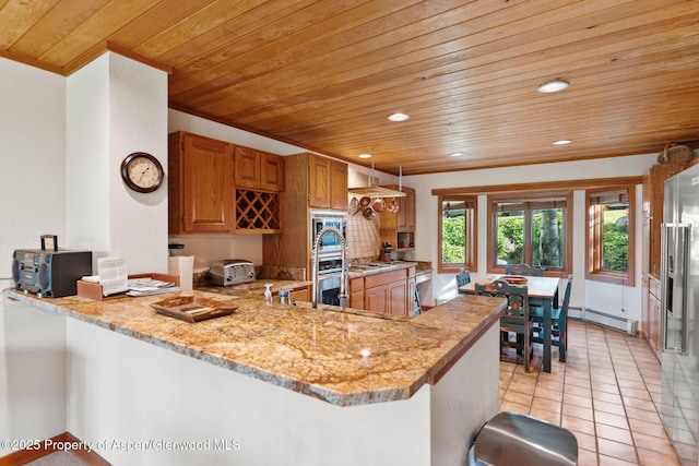 kitchen featuring wood ceiling, tasteful backsplash, a baseboard radiator, kitchen peninsula, and light stone countertops