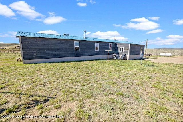 rear view of property featuring a yard