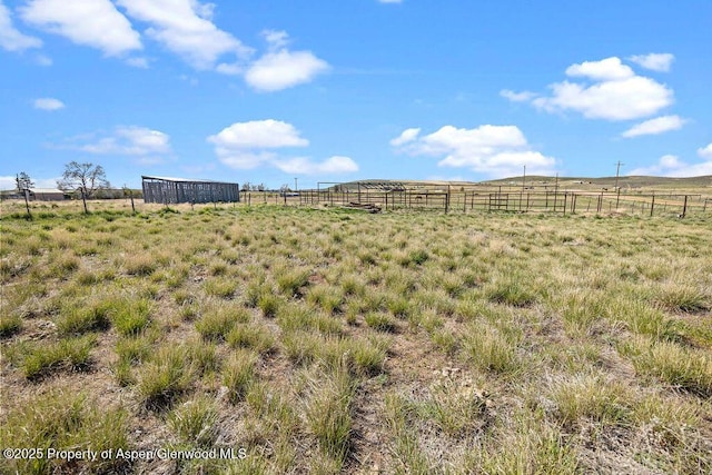 view of yard featuring fence and a view of countryside